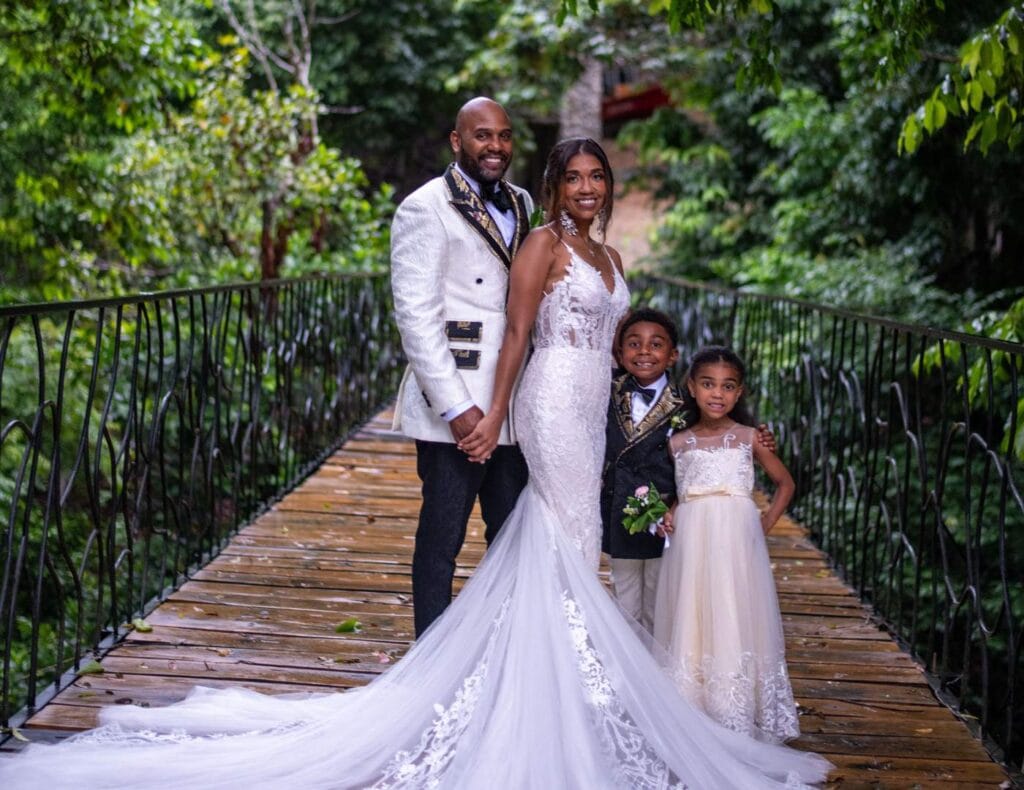 Photo of a couple and their kids in the castle of oz bridge entrance, celebrating their elope in costa rica